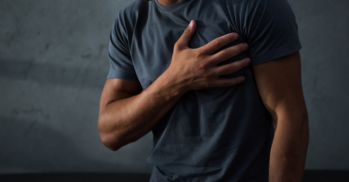 A faceless man holds onto his chest.