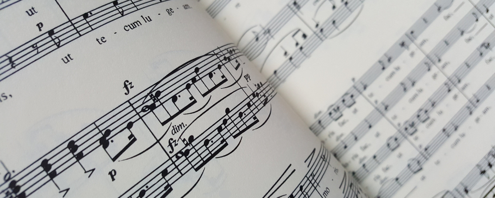 A close-up of sheet music, with musical notes and symbols printed on the page.