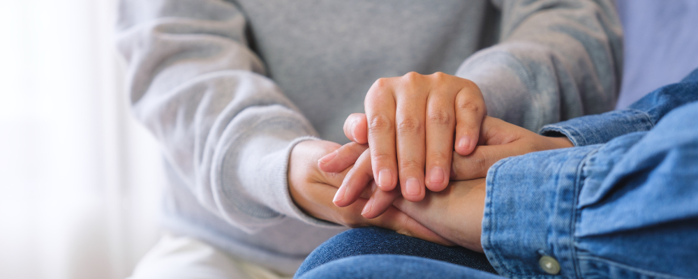 Closeup of hands being held.