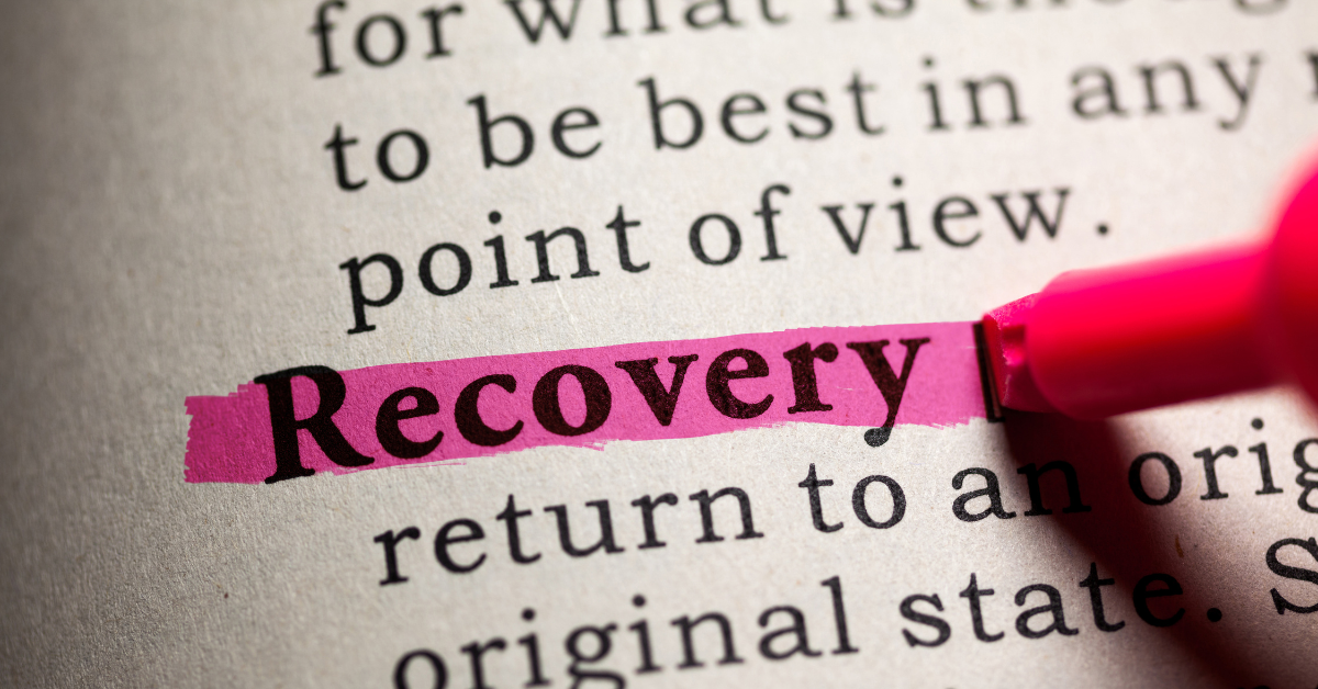 The word "recovery" highlighted in neon pink in a book