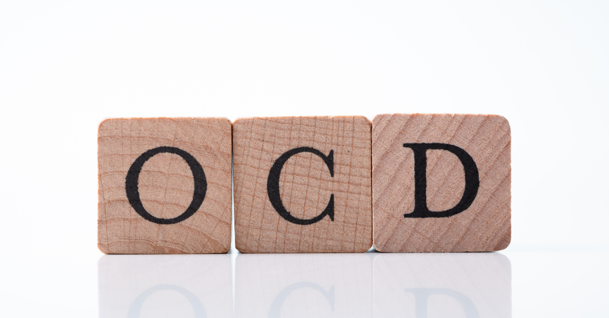 The word "OCD" spelled out in wooden blocks.
