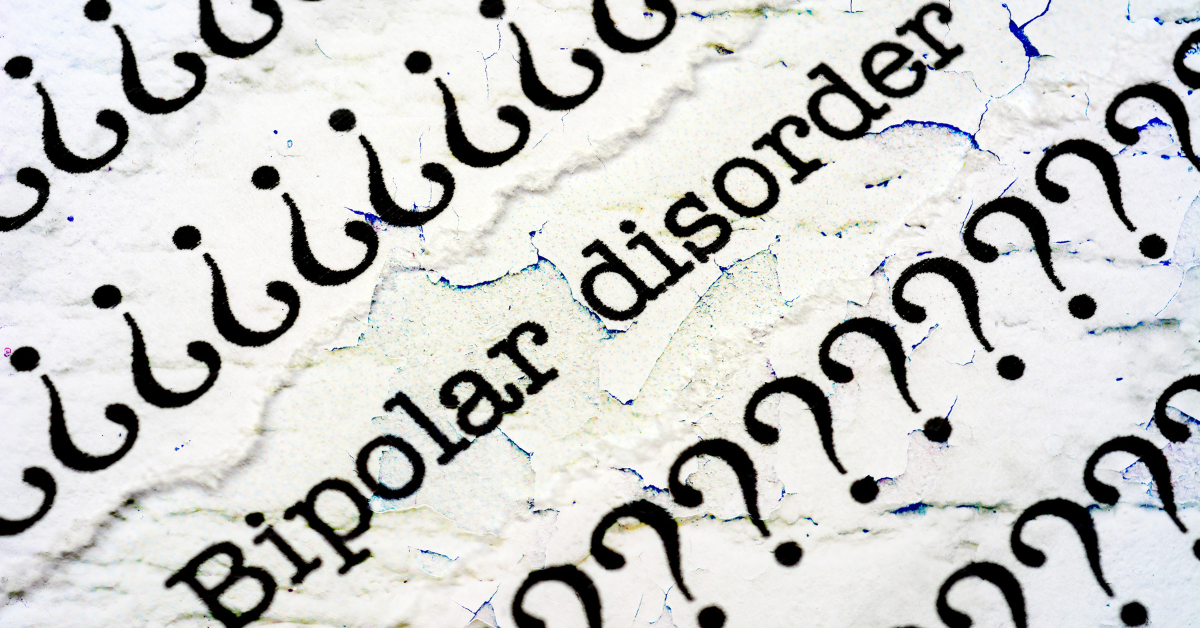 The phrase 'Bipolar disorder' surrounded by numerous question marks on a textured surface, representing confusion or inquiry about the condition.