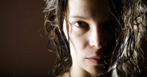 Closeup of a woman staring directly into the camera.