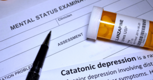Closeup of a prescriptions and paper with the word 'catatonic depression'