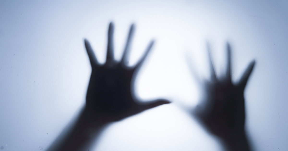 A pair of shadowed hands.