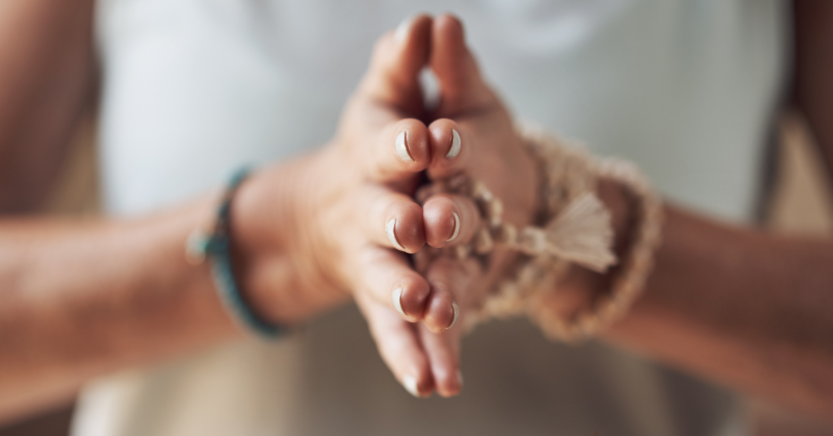 Pair oh hands clasped together in meditation.