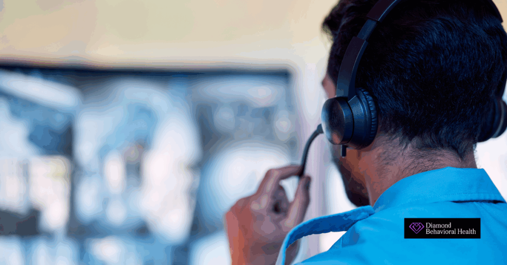 Close-up of a 911 dispatcher wearing a headset, monitoring emergency calls and surveillance screens, representing the high-stress nature of the job and its impact on dispatcher mental health.
